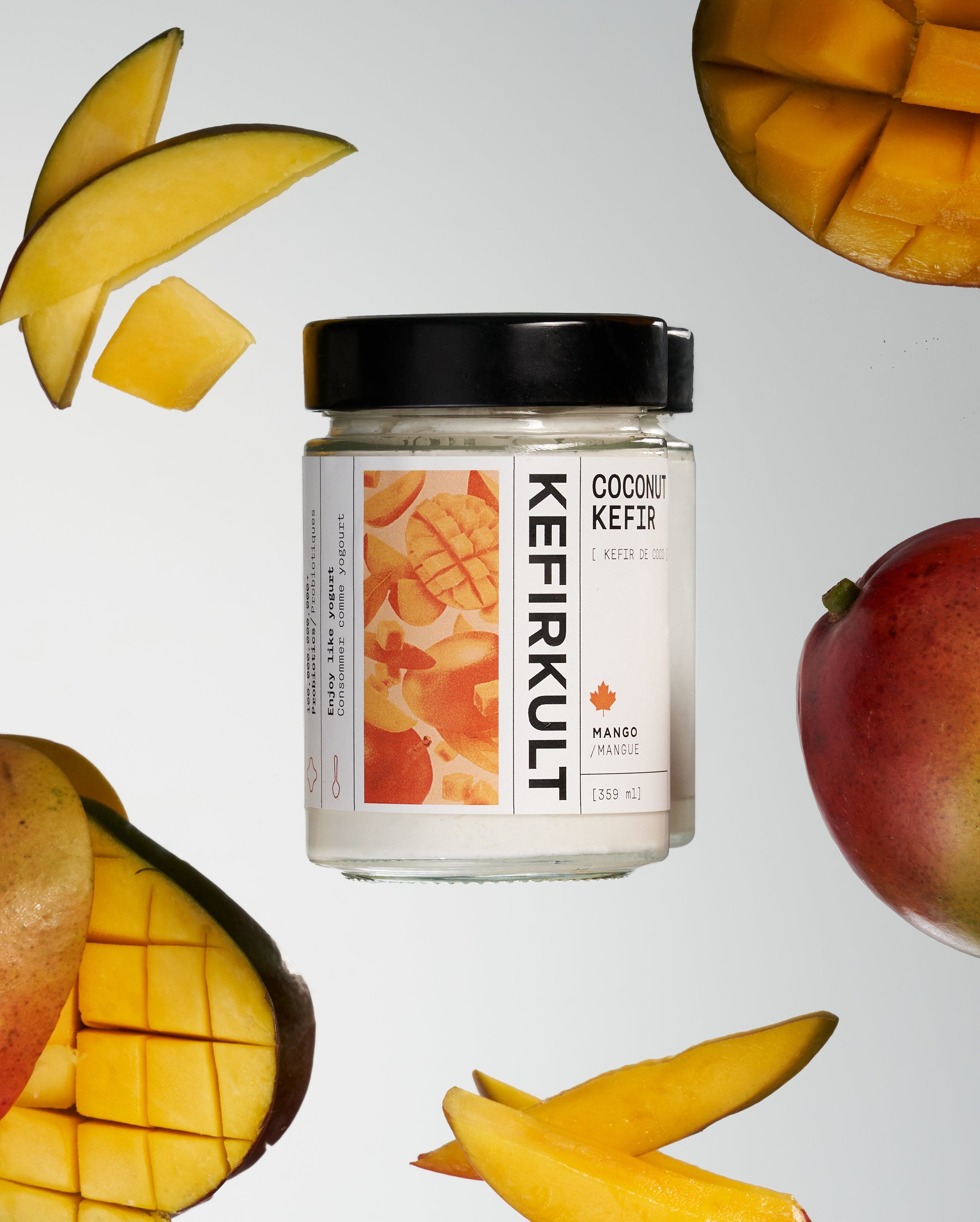 Kefirkult coconut kefir jar, mango flavor label with sliced mango pieces around the jar